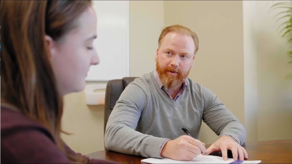 Attorney David M. White reviewing a case with a client