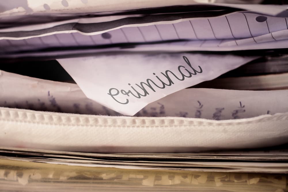 Pile of documents with a visible label marked "Criminal" on top sheet.