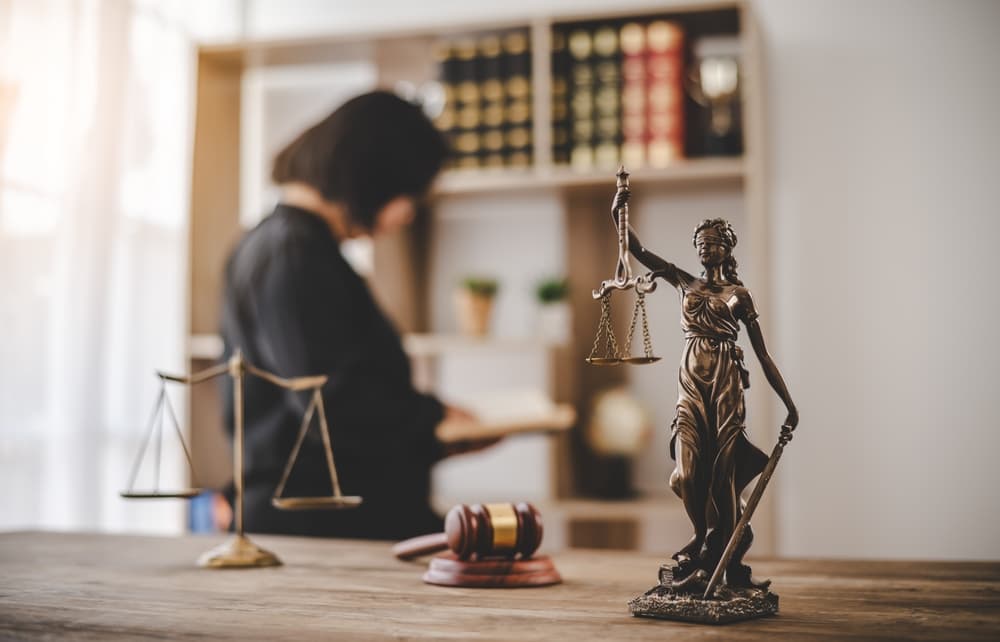 Lady Justice holding scales, symbolizing fairness and equality in legal proceedings.