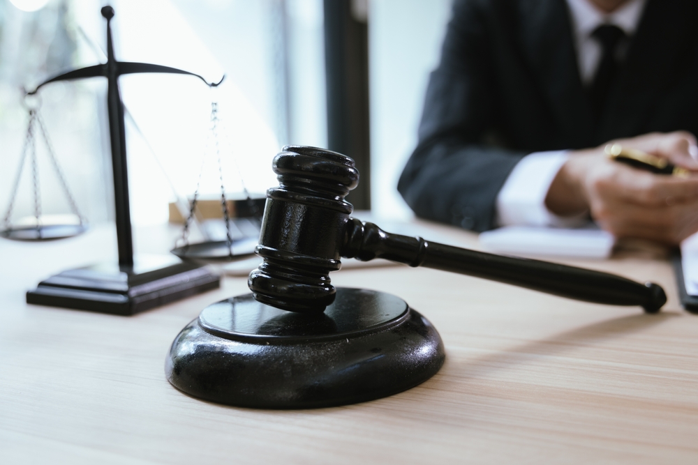 Judge’s gavel and scales of justice on a lawyer’s desk during a truck accident case consultation