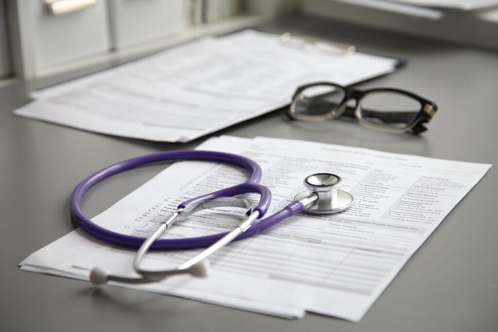 Stethoscope resting on medical paperwork for an expert review